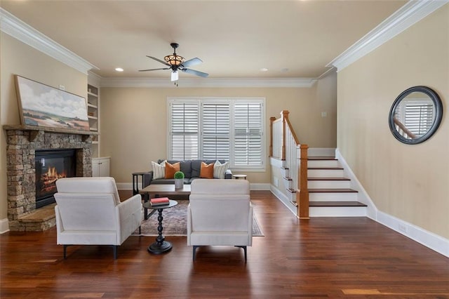 living room featuring crown molding, a stone fireplace, dark hardwood / wood-style floors, and built in shelves