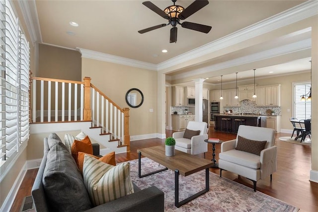 living room featuring crown molding, ceiling fan, and hardwood / wood-style floors