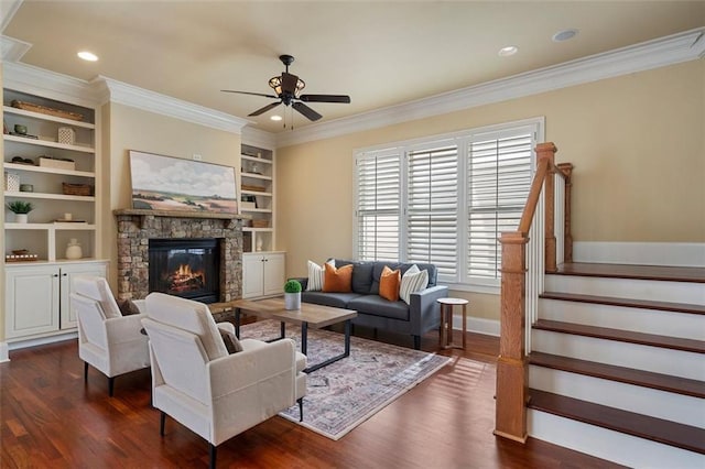 living room featuring dark hardwood / wood-style flooring, built in shelves, plenty of natural light, and ornamental molding