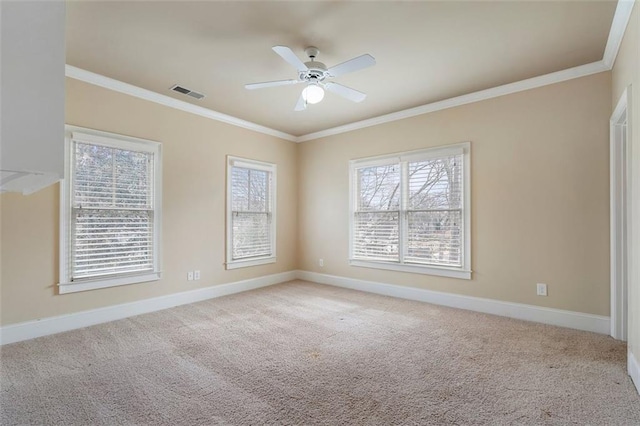 empty room with ornamental molding, light colored carpet, and ceiling fan