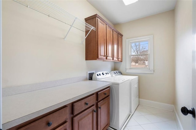 washroom featuring cabinets and separate washer and dryer