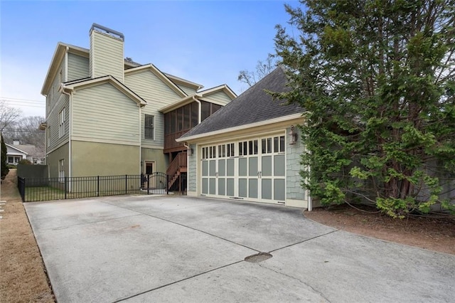 view of front facade featuring a garage and a sunroom