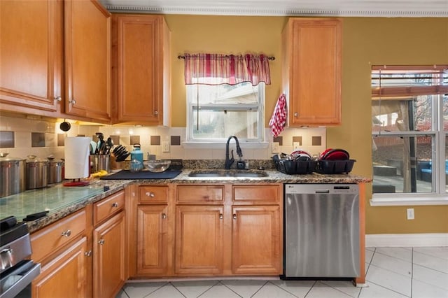 kitchen featuring backsplash, sink, light tile patterned floors, appliances with stainless steel finishes, and stone countertops