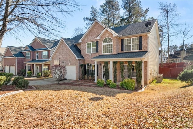 view of front of house with covered porch, a garage, a front lawn, and central AC