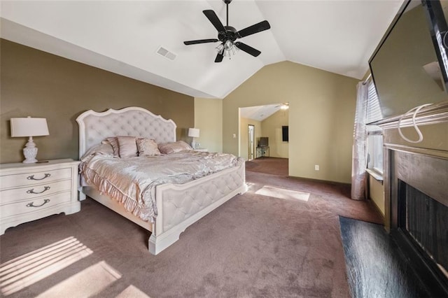 carpeted bedroom with ceiling fan and vaulted ceiling