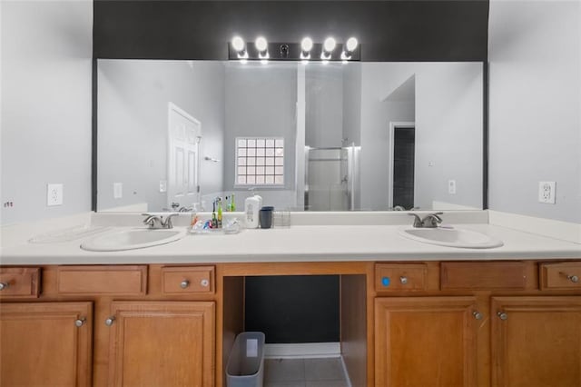 bathroom featuring tile patterned flooring, vanity, and walk in shower