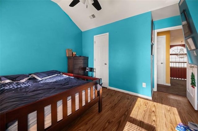 bedroom with hardwood / wood-style flooring, vaulted ceiling, and ceiling fan