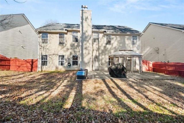 rear view of house with a gazebo and a patio