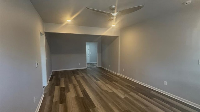 unfurnished room with ceiling fan and dark wood-type flooring