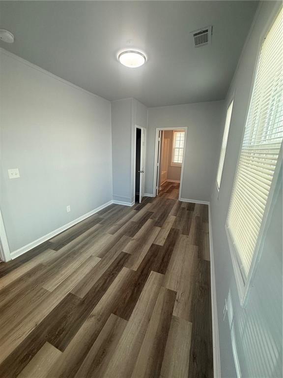 empty room with dark hardwood / wood-style floors