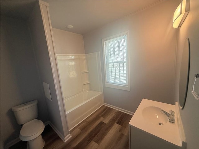 full bathroom featuring toilet, shower / bathtub combination, hardwood / wood-style floors, and vanity