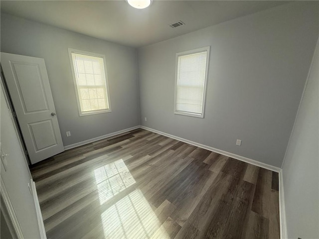 spare room with dark wood-type flooring