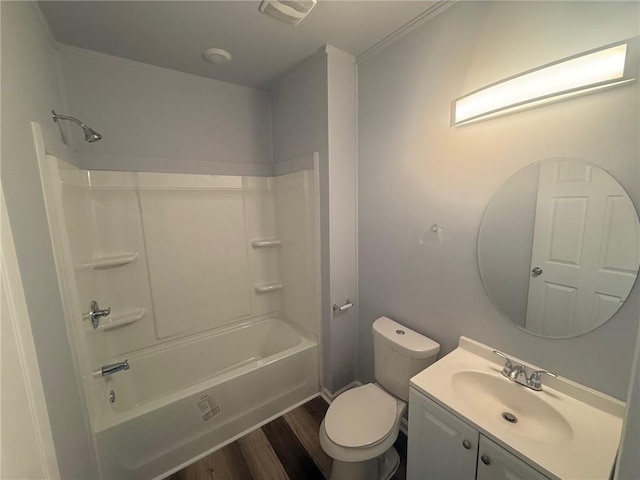 full bathroom featuring toilet, vanity, hardwood / wood-style floors, shower / bathtub combination, and ornamental molding