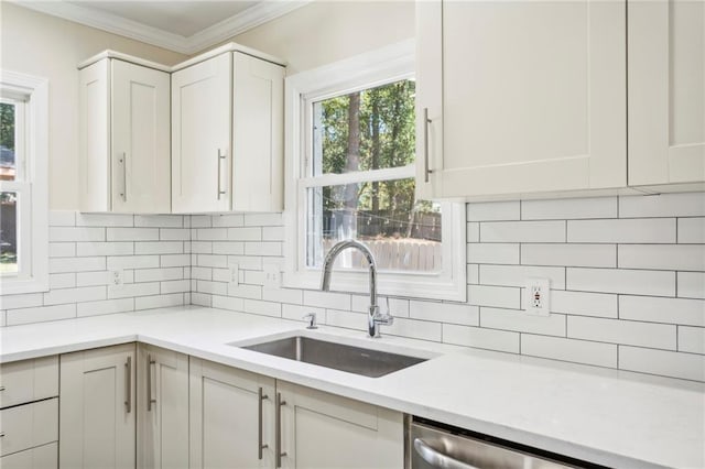 kitchen featuring sink, white cabinetry, ornamental molding, dishwasher, and backsplash