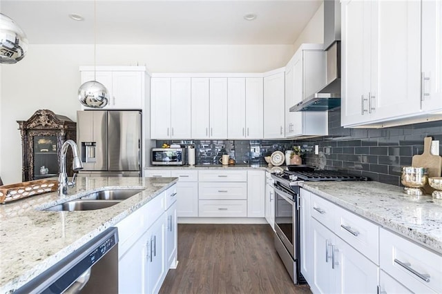 kitchen featuring stainless steel appliances, white cabinetry, sink, and wall chimney exhaust hood