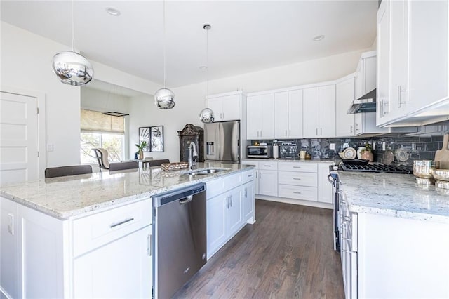 kitchen with stainless steel appliances, an island with sink, and white cabinets