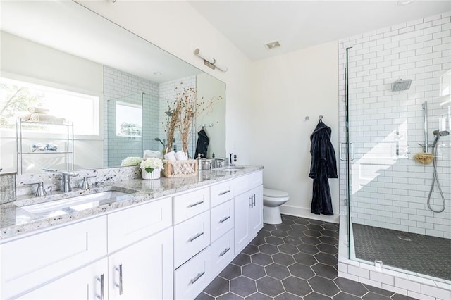 bathroom featuring an enclosed shower, vanity, tile patterned floors, and toilet