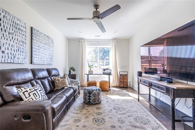 living room featuring hardwood / wood-style floors and ceiling fan