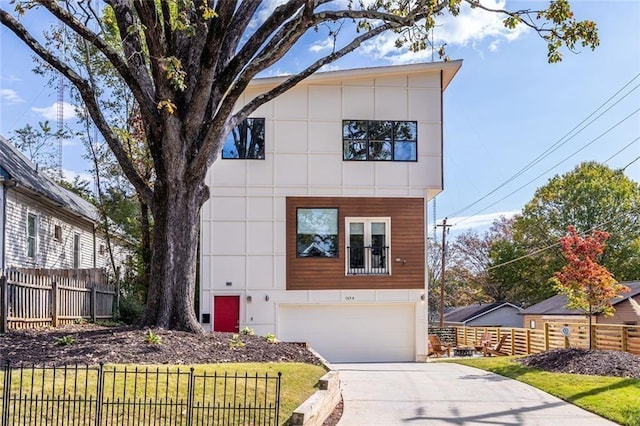 modern home featuring a garage and a front lawn