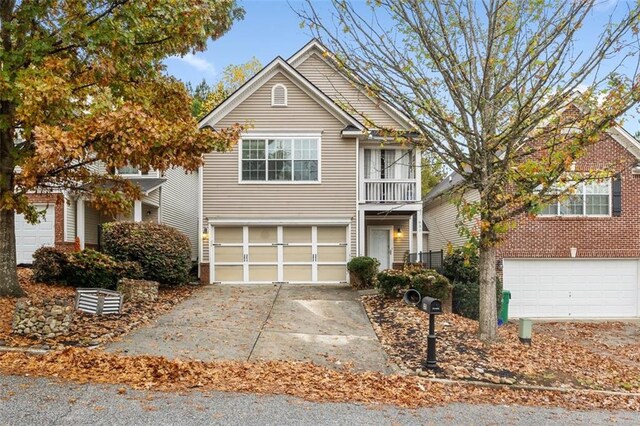 front of property featuring a garage and a balcony