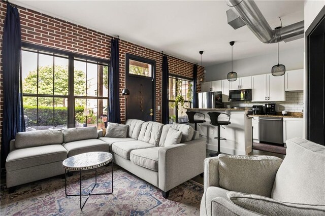 living area with brick wall