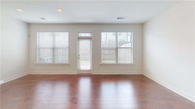 unfurnished room with recessed lighting, baseboards, visible vents, and wood finished floors
