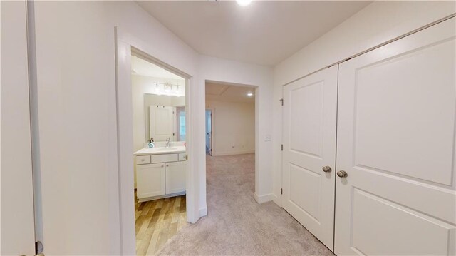 corridor with light hardwood / wood-style floors