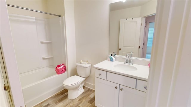 full bathroom featuring toilet, hardwood / wood-style flooring, tub / shower combination, and vanity