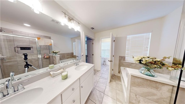 bathroom featuring vanity, tile patterned flooring, and shower with separate bathtub