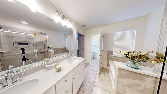 bathroom featuring a sink, a garden tub, double vanity, and visible vents