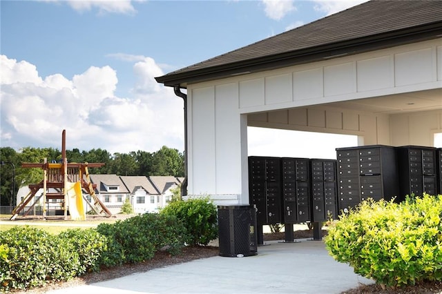 view of property's community featuring playground community and mail area