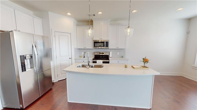 kitchen featuring a center island with sink, sink, appliances with stainless steel finishes, and dark hardwood / wood-style flooring