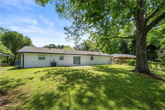 2159 Fairburn Rd SW, Atlanta, GA 30331 - rear view of house with a yard, brick siding, and cooling unit