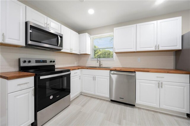 2159 Fairburn Rd SW, Atlanta, GA 30331 - kitchen with butcher block countertops, appliances with stainless steel finishes, a sink, and recessed lighting