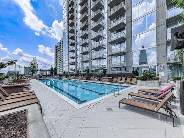 community pool with a patio area