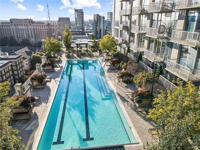 pool featuring a patio area and a city view