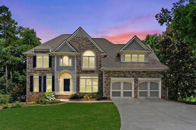 view of front of property with a lawn and a garage