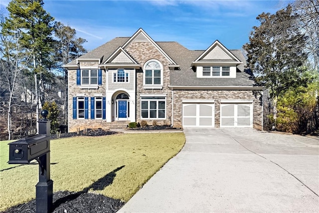 view of front of house with a front yard, brick siding, and driveway