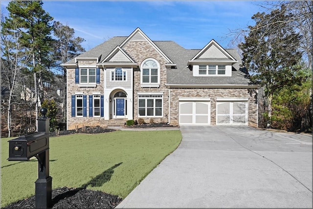 view of front of home featuring a garage, driveway, roof with shingles, and a front yard