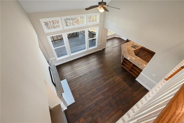 living room featuring ceiling fan, dark hardwood / wood-style flooring, and high vaulted ceiling