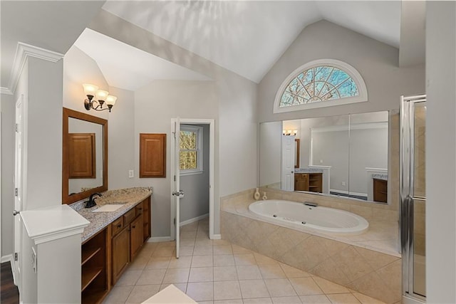 bathroom with tile patterned floors, vanity, a healthy amount of sunlight, and lofted ceiling