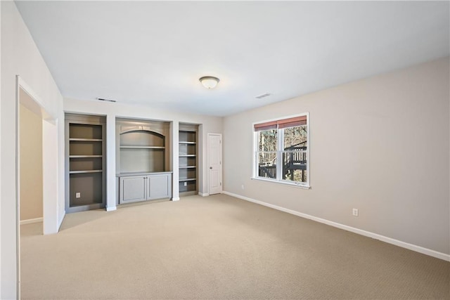 unfurnished living room with light colored carpet