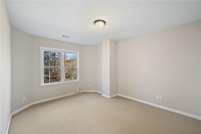 empty room featuring light colored carpet