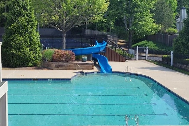 view of swimming pool with a water slide