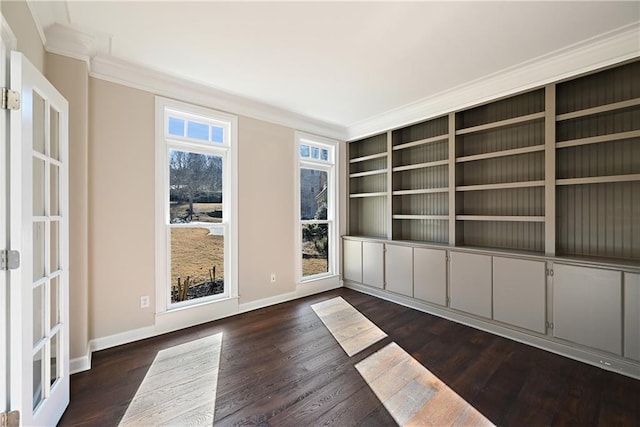 empty room featuring dark hardwood / wood-style floors and crown molding