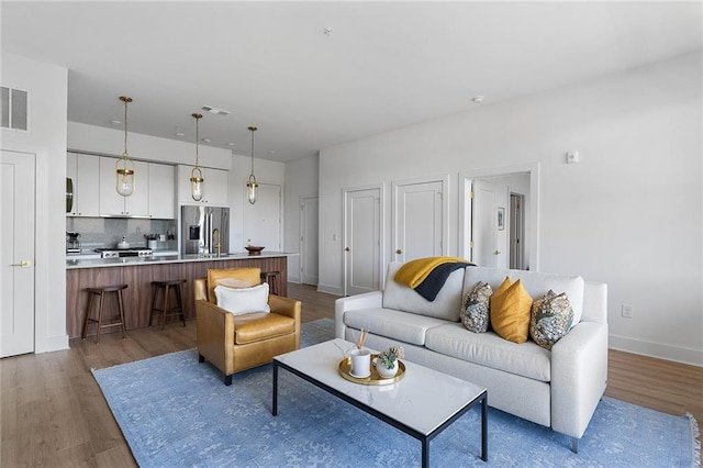 living room featuring sink and hardwood / wood-style flooring