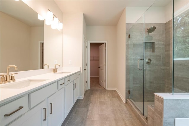 7505 Woolf Way, Cumming, GA 30028 - bathroom with a shower stall, double vanity, and a spacious closet