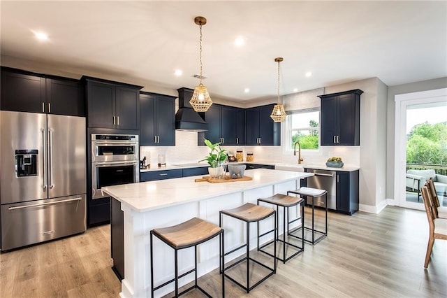 7505 Woolf Way, Cumming, GA 30028 - kitchen with stainless steel appliances, custom range hood, a kitchen bar, plenty of natural light, and recessed lighting