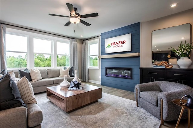 7505 Woolf Way, Cumming, GA 30028 - living room with a large fireplace, light wood-style flooring, a ceiling fan, baseboards, and recessed lighting