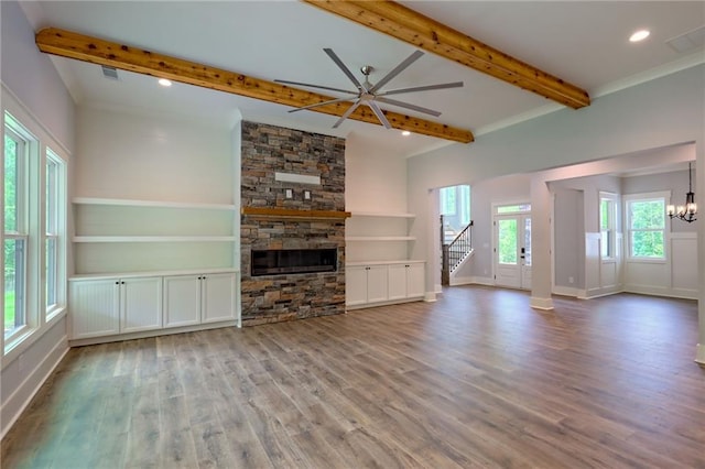 6449 Snelling Mill Rd, Flowery Branch, GA 30542 - unfurnished living room featuring wood finished floors, a fireplace, stairway, baseboards, and beamed ceiling